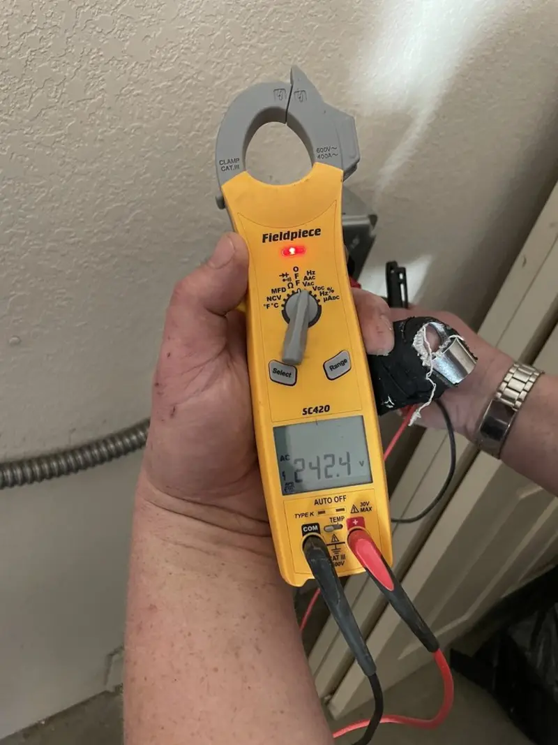 Voltage testing with clamp meter during Recessed Lighting Installation in Jasper
